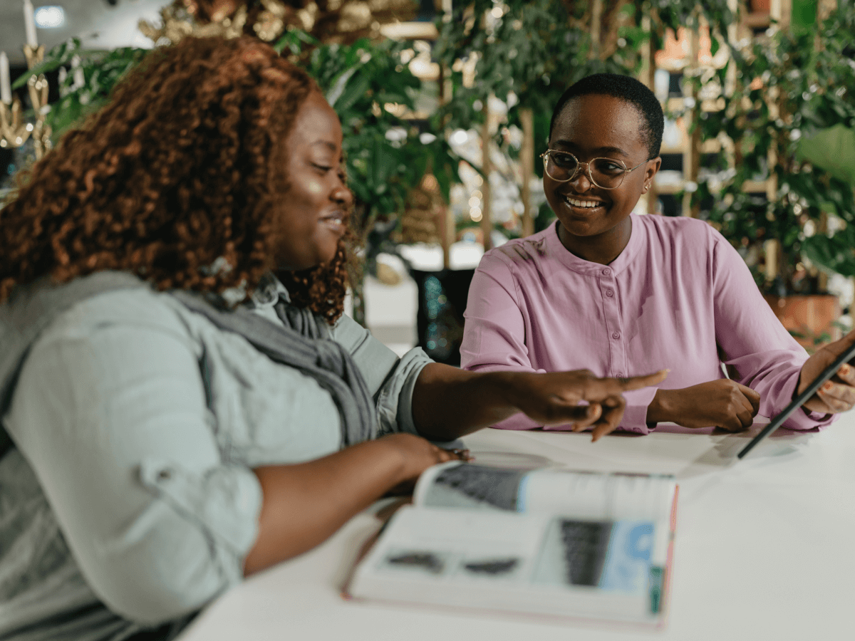 Smiling colleagues reviewing tablet